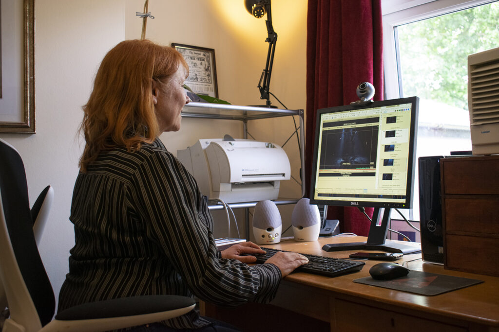 Woman working on subtitles on a desktop computer