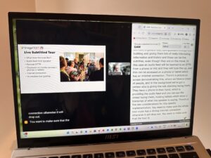 Photo of Oliver Webster presenting a webinar. On the screen is his presentation, a small image of him and the transcript to the right of the screen.