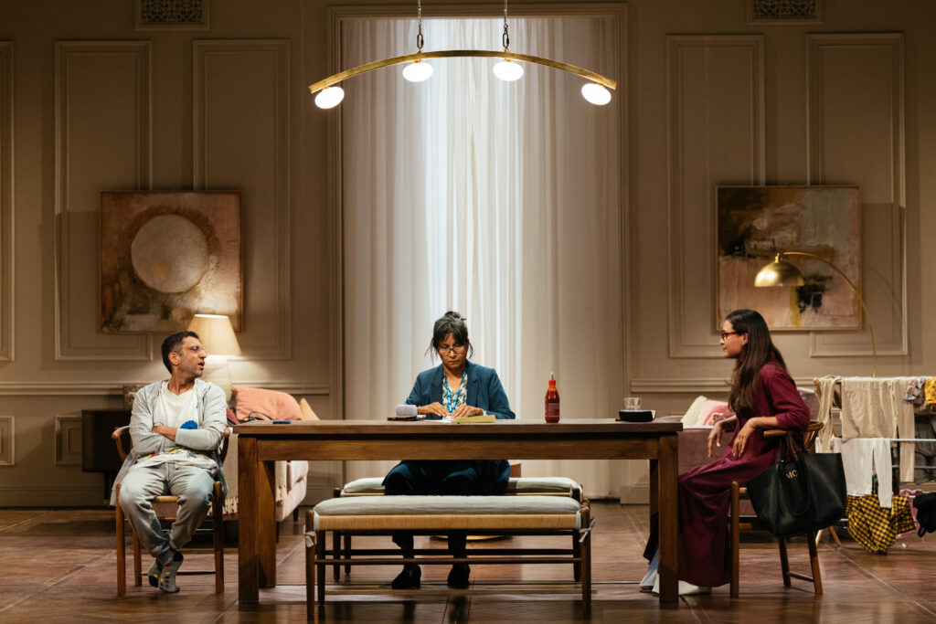 inside a home with three people around a table.